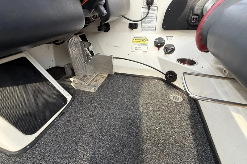 Slide: The Image of Interior of a 2016 Nitro Z21 boat showing foot pedal and dashboard controls. - 20