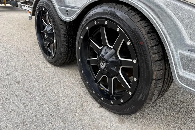 Slide: The Image of 2016 Nitro Z21 trailer with black alloy wheels on a textured road surface. - 25