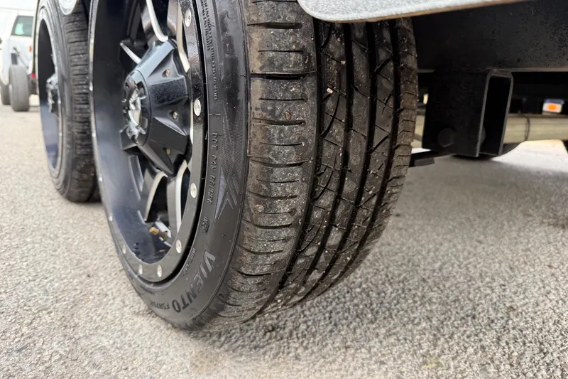 Slide: The Image of Close-up of a 2016 Nitro Z21 tire on asphalt, showcasing tread and wheel design. - 26