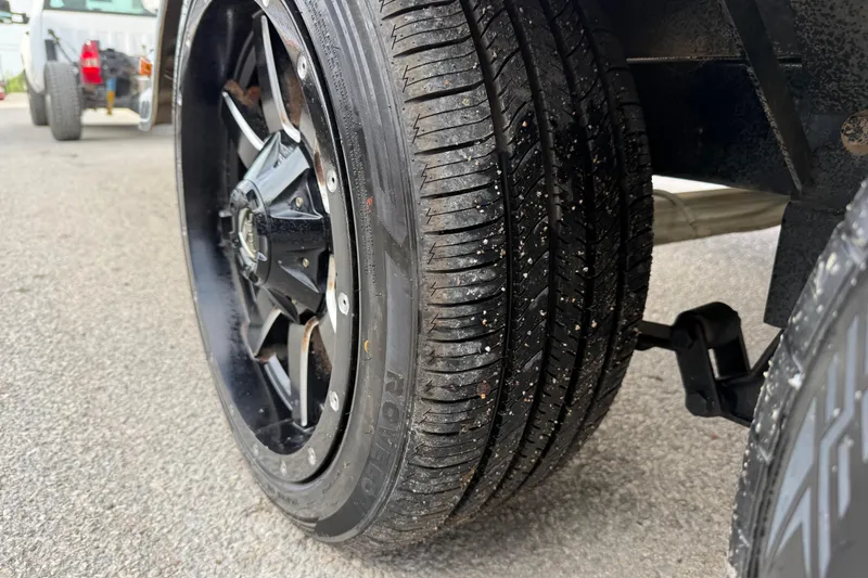 Slide: The Image of Close-up of a 2016 Nitro Z21 tire and black alloy wheel on pavement. - 27