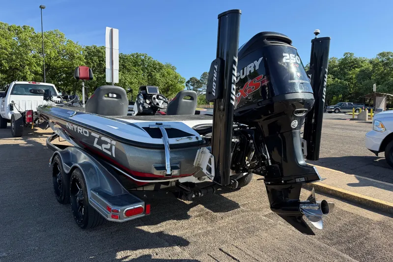 Slide: The Image of 2016 Nitro Z21 boat with Mercury 250 XS engine on trailer in parking lot. - 44