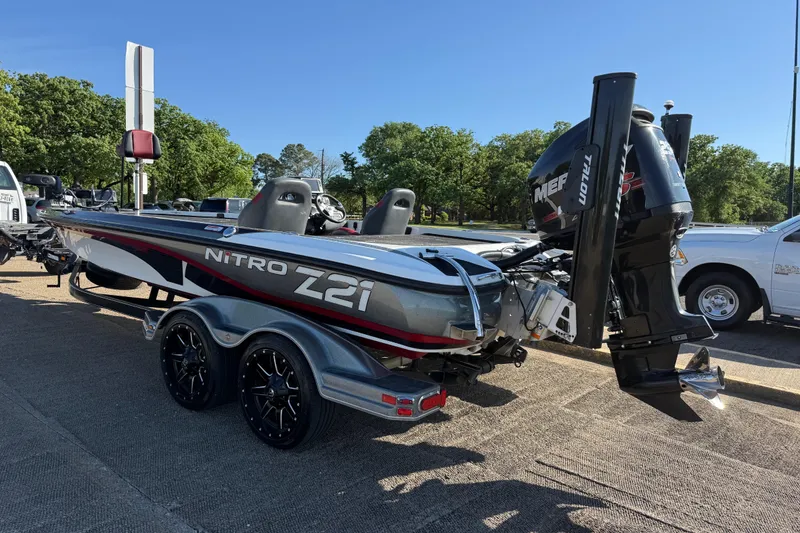 Slide: The Image of 2016 Nitro Z21 boat on trailer with powerful outboard motor, parked outdoors. - 45