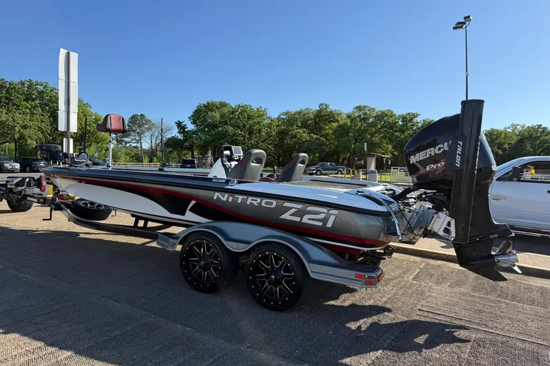 Slide: The Image of 2016 Nitro Z21 boat with Mercury engine on trailer, parked outdoors. - 46