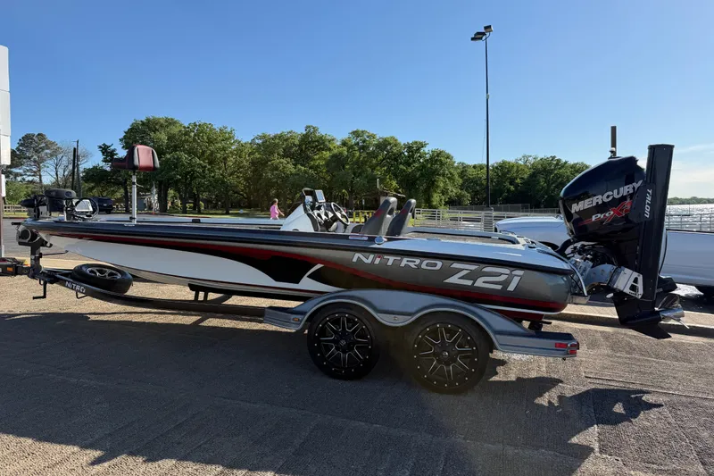 Slide: The Image of 2016 Nitro Z21 boat with Mercury Pro XS engine on trailer, parked outdoors. - 47
