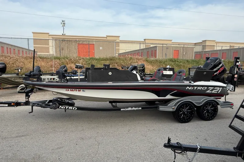 Slide: The Image of 2016 Nitro Z21 boat on trailer, parked outdoors near storage facility. - 5