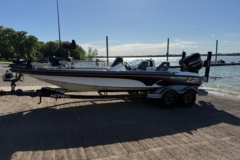 Slide: The Image of 2016 Nitro Z21 boat on trailer by a lakeside, ready for fishing adventure. - 50