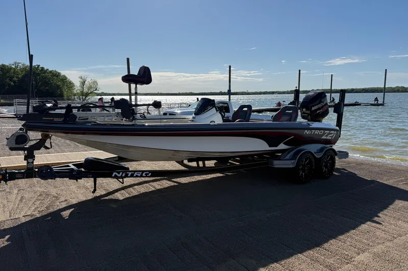Slide: The Image of 2016 Nitro Z21 boat on trailer by a lake, ready for launch. - 51