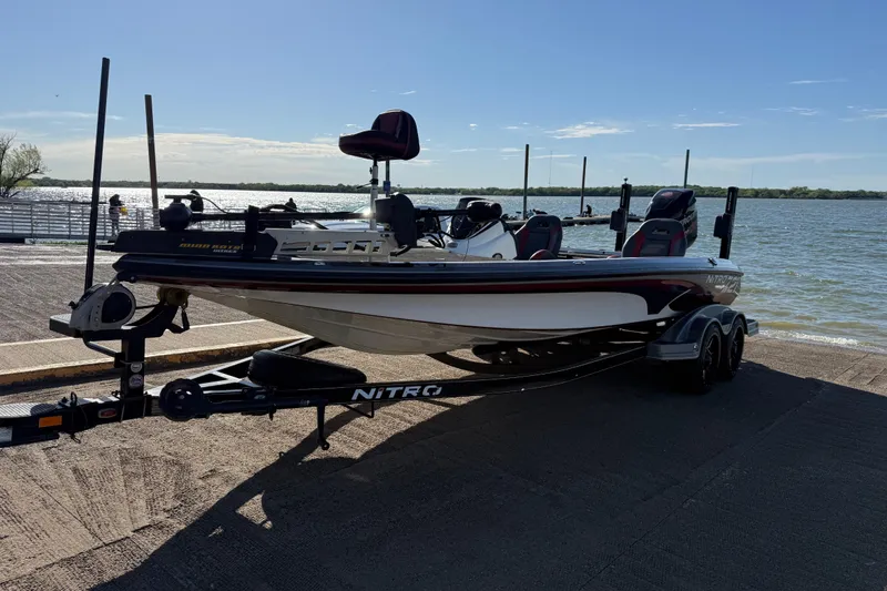 Slide: The Image of 2016 Nitro Z21 boat on trailer by a lakeside, ready for launch. - 52