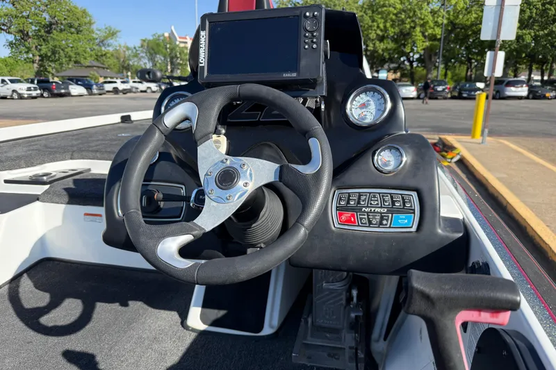 Slide: The Image of 2016 Nitro Z21 boat dashboard with steering wheel and electronic controls. - 57