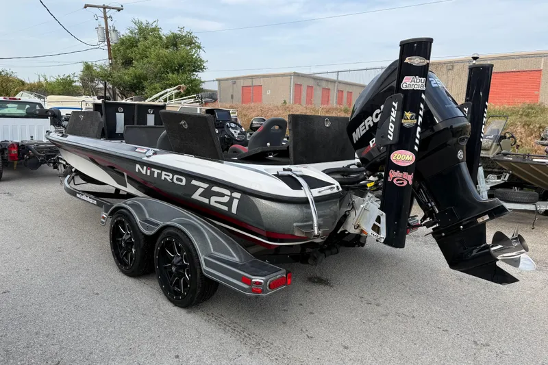 Slide: The Image of 2016 Nitro Z21 boat with Mercury engine on a trailer, parked outdoors. - 6