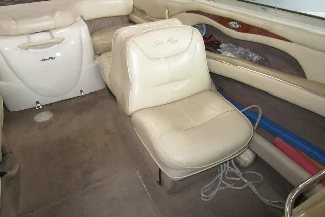 Slide: The Image of Interior of a 2000 Sea Ray 210 Signature boat with beige seating and carpet. - 10