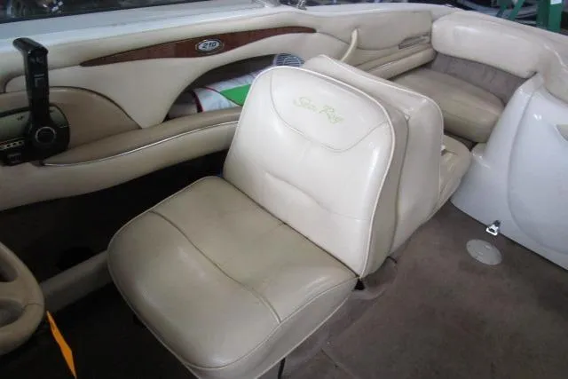 Slide: The Image of Interior of 2000 Sea Ray 210 Signature boat with beige leather seating. - 11