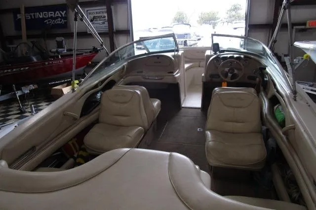 Slide: The Image of Interior of a 2000 Sea Ray 210 Signature boat with beige seating and steering wheel. - 12
