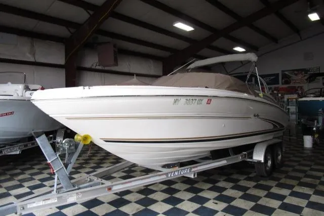 Slide: The Image of 2000 Sea Ray 210 Signature boat on trailer in indoor storage facility. - 14