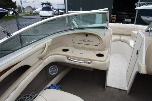 Slide: The Image of Interior of a 2000 Sea Ray 210 Signature boat with beige seating and cup holders. - 20