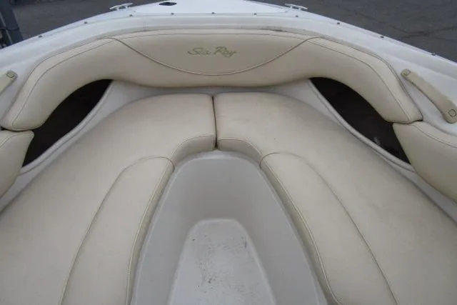 Slide: The Image of Bow seating area of a 2000 Sea Ray 210 Signature boat with cream upholstery. - 21