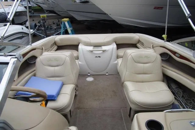 Slide: The Image of Interior of a 2000 Sea Ray 210 Signature boat with beige seating. - 22