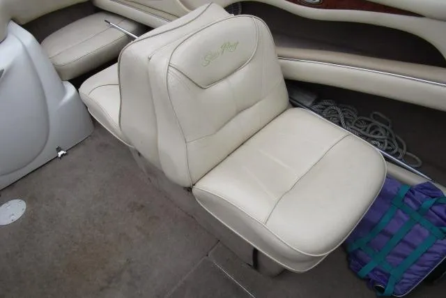Slide: The Image of 2000 Sea Ray 210 Signature boat interior with beige seating and storage area. - 23