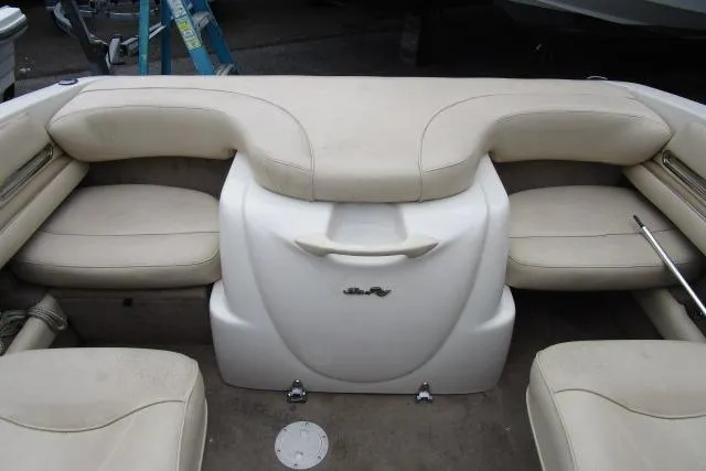 Slide: The Image of 2000 Sea Ray 210 Signature boat interior with beige seating and storage compartment. - 26