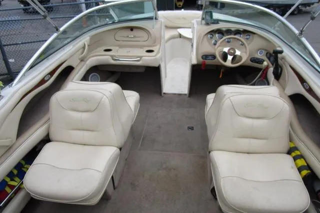Slide: The Image of Interior of 2000 Sea Ray 210 Signature boat with beige seating and dashboard. - 27