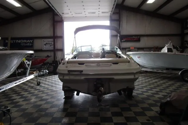 Slide: The Image of 2000 Sea Ray 210 Signature boat in a showroom with checkered flooring. - 3