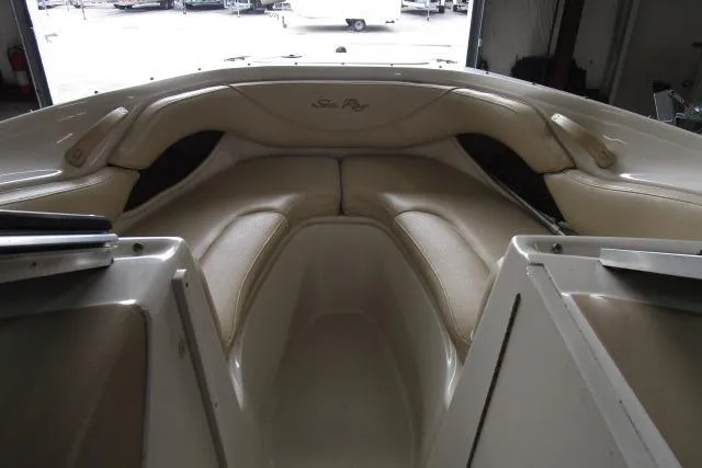 Slide: The Image of Interior view of a 2000 Sea Ray 210 Signature boat, featuring beige seating. - 4