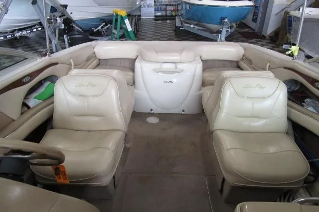 Slide: The Image of Interior of a 2000 Sea Ray 210 Signature boat with beige leather seating. - 7