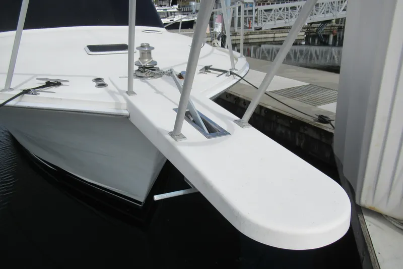 Slide: The Image of Bow of 1990 Viking 38 Convertible yacht docked at marina. - 10