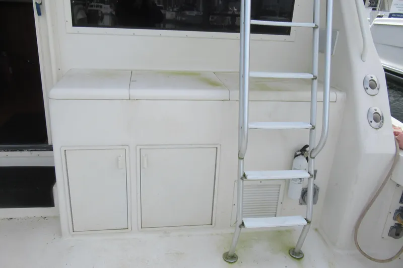 Slide: The Image of 1990 Viking 38 Convertible yacht ladder and storage compartments on deck. - 13
