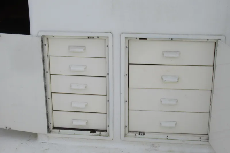 Slide: The Image of White storage drawers on a 1990 Viking 38 Convertible boat. - 14