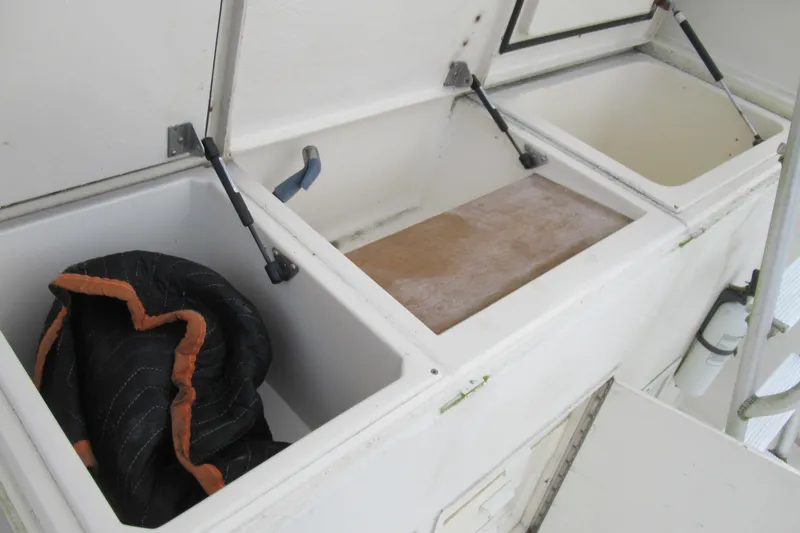 Slide: The Image of Open storage compartments on a 1990 Viking 38 Convertible boat deck. - 15