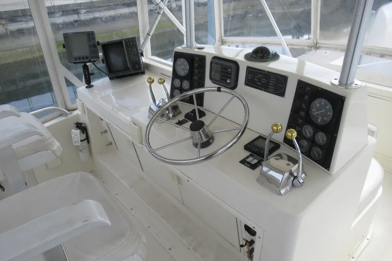 Slide: The Image of Cockpit of 1990 Viking 38 Convertible boat with steering wheel and navigation instruments. - 16