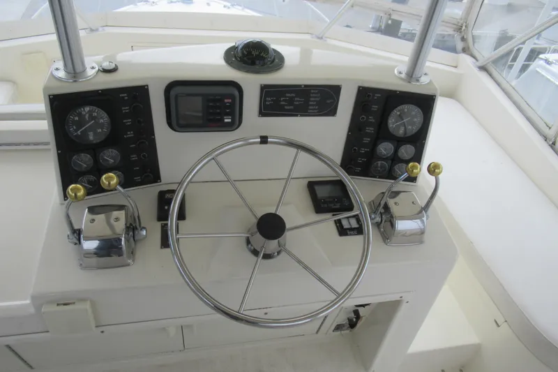 Slide: The Image of Control panel of a 1990 Viking 38 Convertible yacht with steering wheel and gauges. - 17