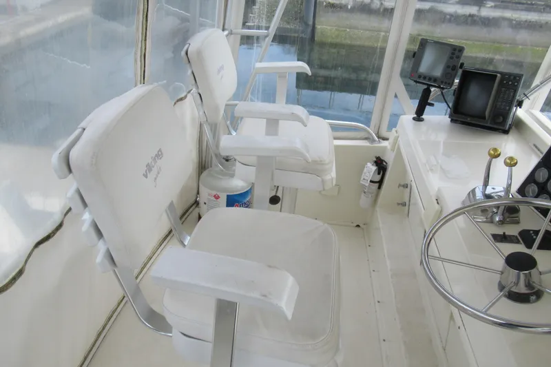 Slide: The Image of Interior of 1990 Viking 38 Convertible yacht with helm, chairs, and navigation equipment. - 18
