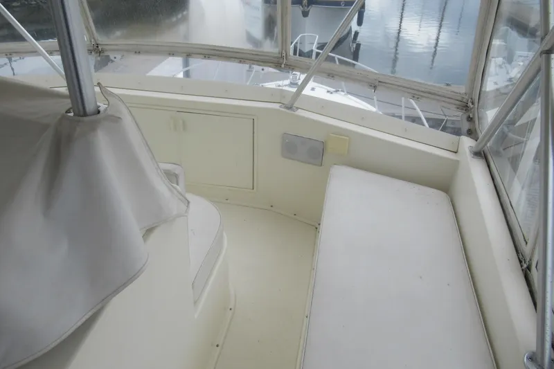 Slide: The Image of Interior view of a 1990 Viking 38 Convertible boat, featuring seating and storage. - 19