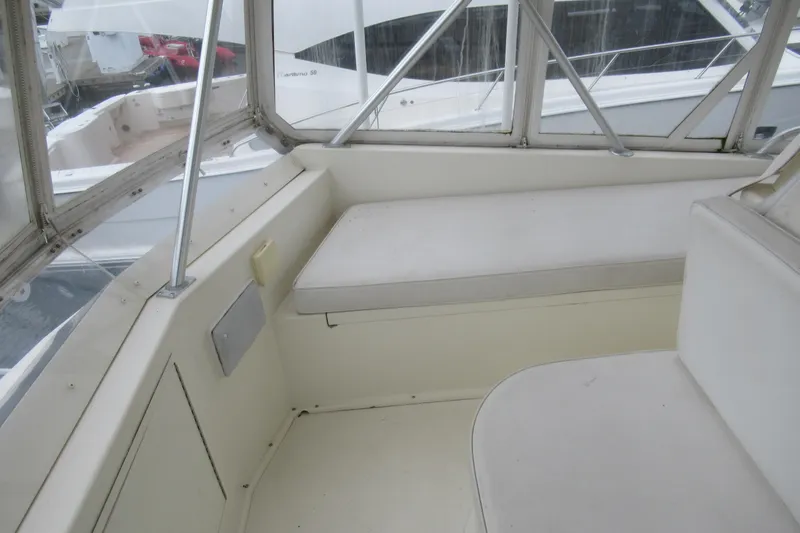 Slide: The Image of Interior view of a 1990 Viking 38 Convertible yacht with white seating. - 21