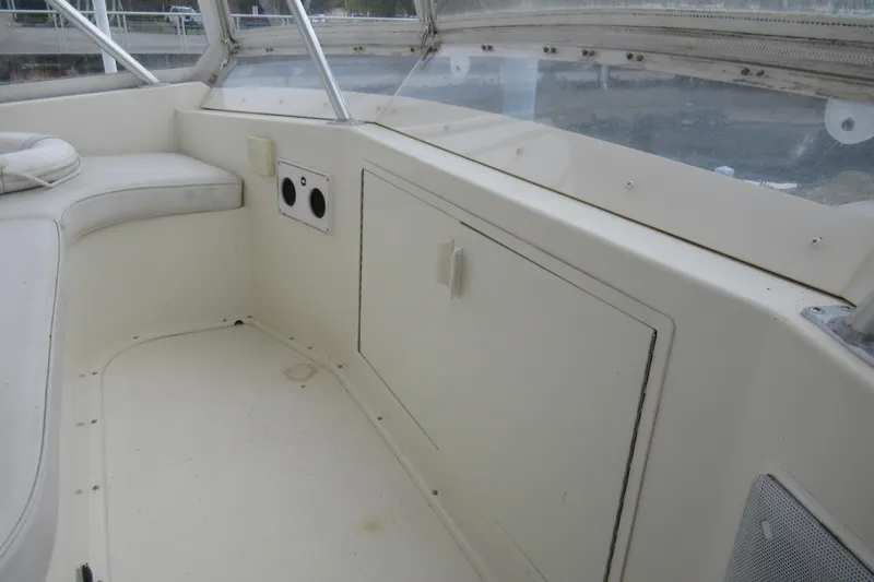 Slide: The Image of Interior view of a 1990 Viking 38 Convertible boat, featuring seating and storage compartments. - 22
