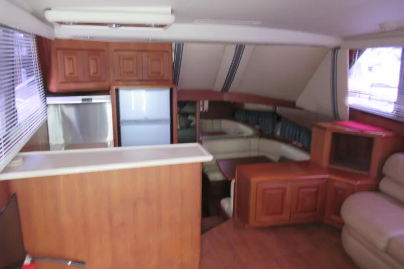 Slide: The Image of Interior of 1990 Viking 38 Convertible yacht with wood cabinetry and seating area. - 25