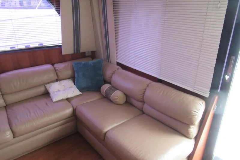 Slide: The Image of Luxurious interior of 1990 Viking 38 Convertible yacht with beige leather seating and cushions. - 26