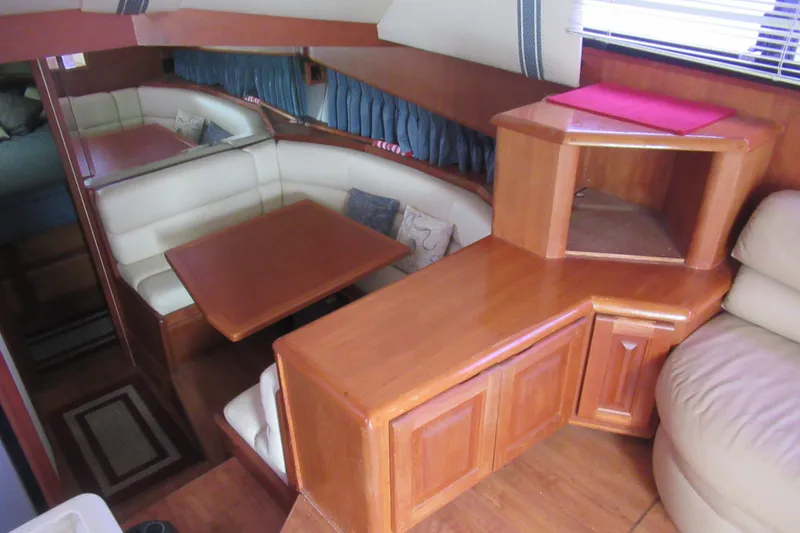 Slide: The Image of Interior of 1990 Viking 38 Convertible yacht with wood cabinetry and dining area. - 27