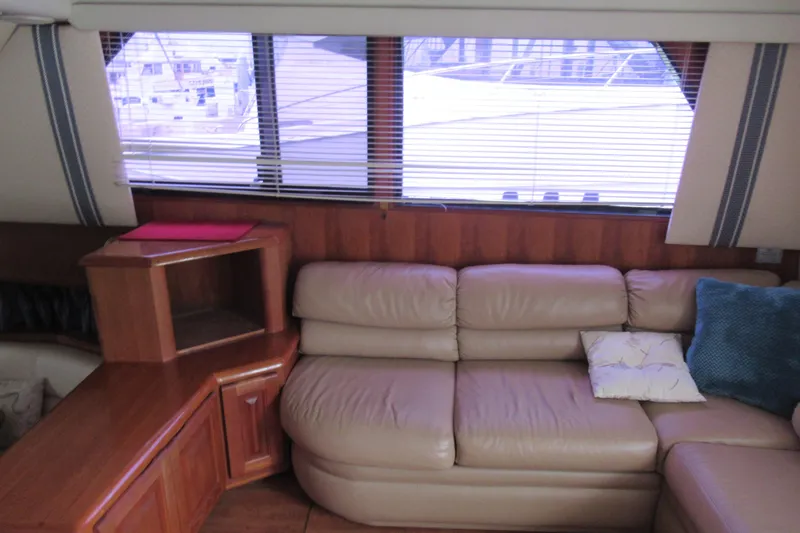 Slide: The Image of Interior of 1990 Viking 38 Convertible yacht with leather seating and wooden cabinetry. - 28