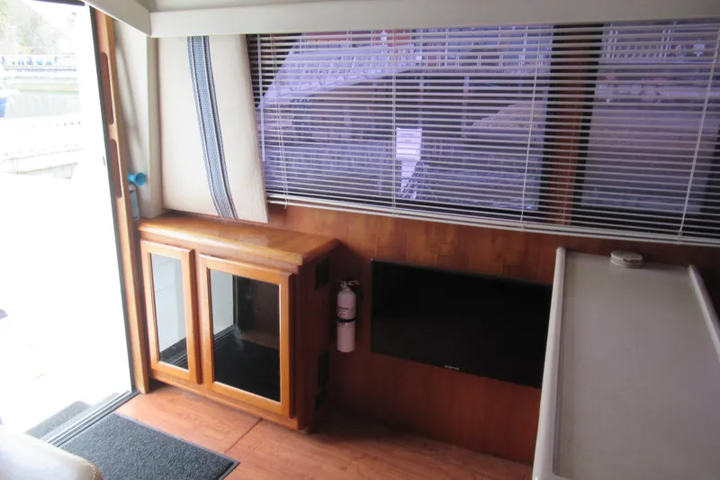 Slide: The Image of Interior of 1990 Viking 38 Convertible yacht with wood cabinetry and window blinds. - 29