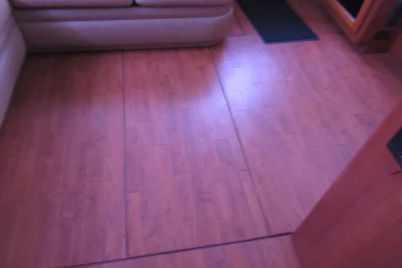 Slide: The Image of Interior view of 1990 Viking 38 Convertible with wooden flooring and beige seating. - 32