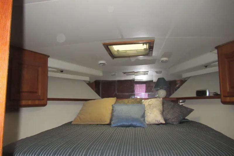Slide: The Image of Cozy cabin interior of 1990 Viking 38 Convertible yacht with pillows and wooden cabinets. - 36