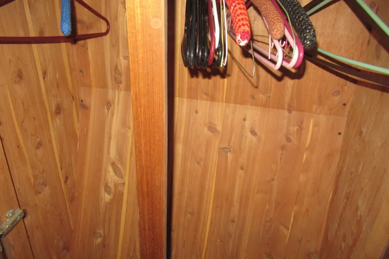 Slide: The Image of Wooden closet interior with assorted hangers, Viking 38 Convertible, 1990 model. - 39
