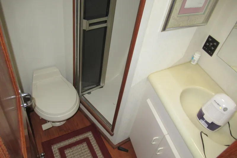 Slide: The Image of Bathroom interior of 1990 Viking 38 Convertible yacht with toilet, sink, and shower. - 40