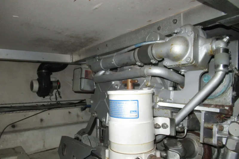 Slide: The Image of Engine room of a 1990 Viking 38 Convertible boat, showcasing mechanical components. - 46