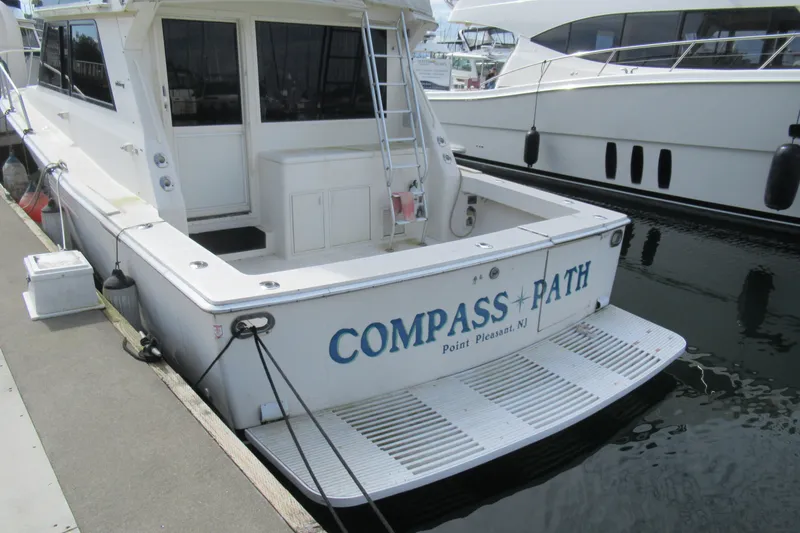 Slide: The Image of 1990 Viking 38 Convertible boat docked, named "Compass Path," Point Pleasant, NJ. - 7