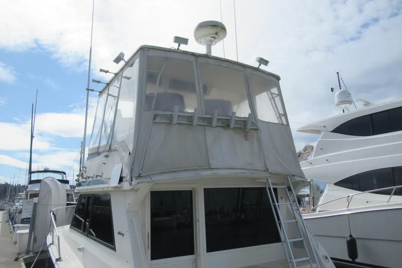 Slide: The Image of 1990 Viking 38 Convertible yacht docked at marina under cloudy sky. - 8