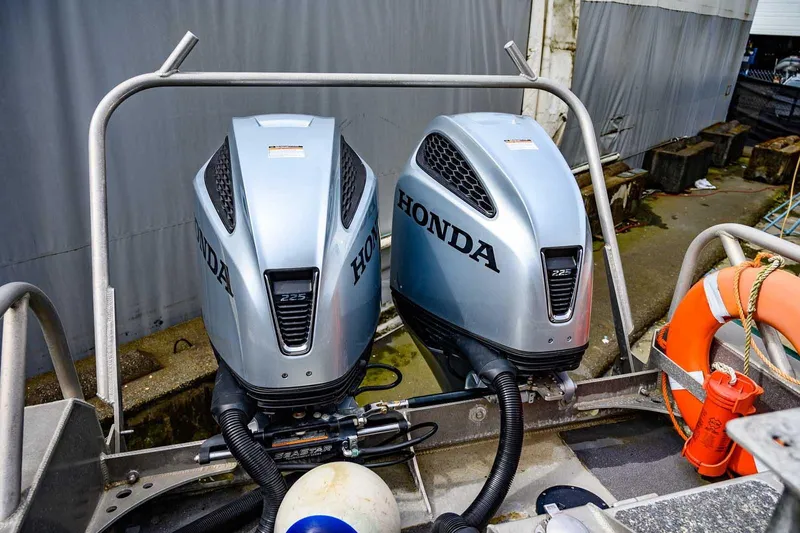 Slide: The Image of Twin Honda 225 outboard engines on a 2004 SAFE Boats Defender. - 11